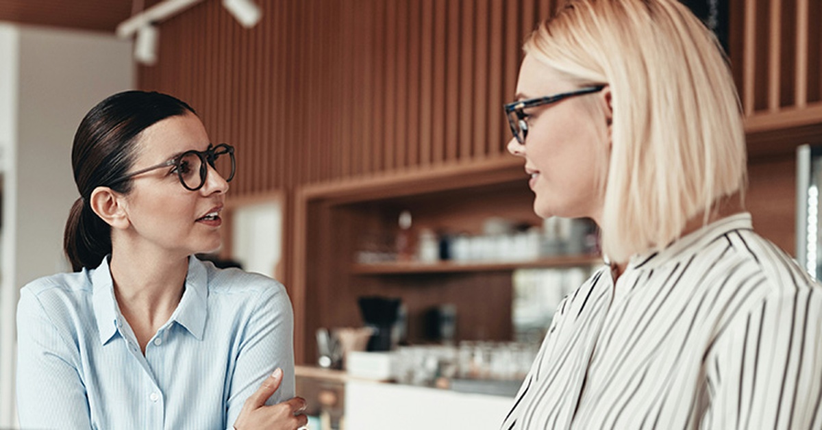 Two women in an office discussing quantum computing investment